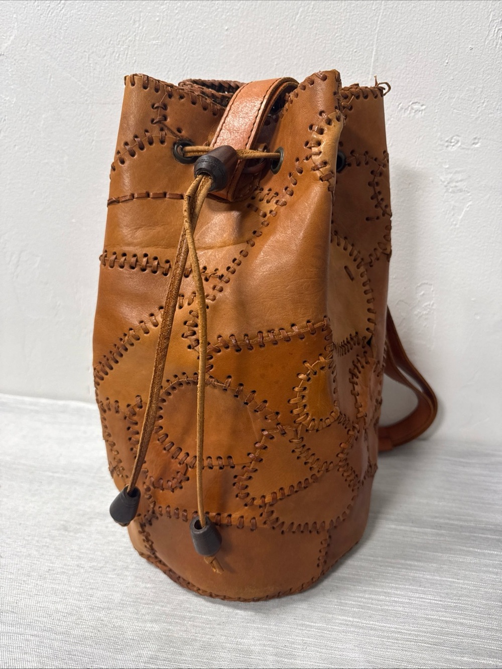 Stitched Patchwork Drawstring Crossbody Bag in Tan
